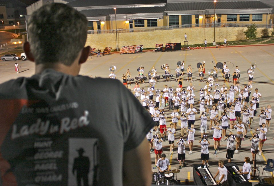 Watching a marching band rehearsal from the director's tower at night.