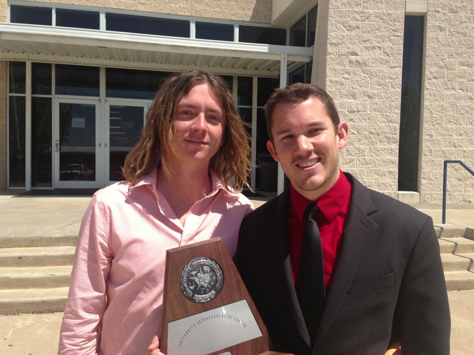 Holding a UIL competition award with a colleague.